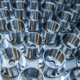 A Batch Of Shiny Metal Cnc Aerospace Parts Production Close Up With Selective Focus For Industrial Background