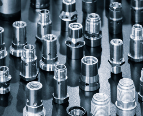 Close Up Of Various Metallic Threaded Fasteners On Dark Surface